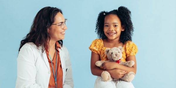 Doctor,And,Girl,Patient,Girl,In,Clinic.,Smiling,Pediatrician,With